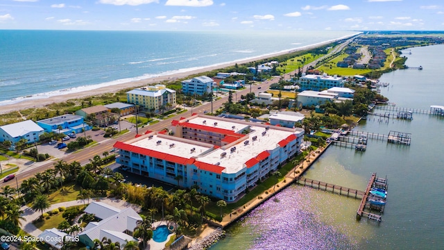 aerial view with a water view and a beach view