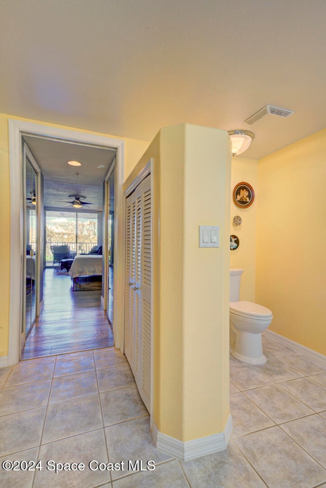 hall featuring light tile patterned flooring