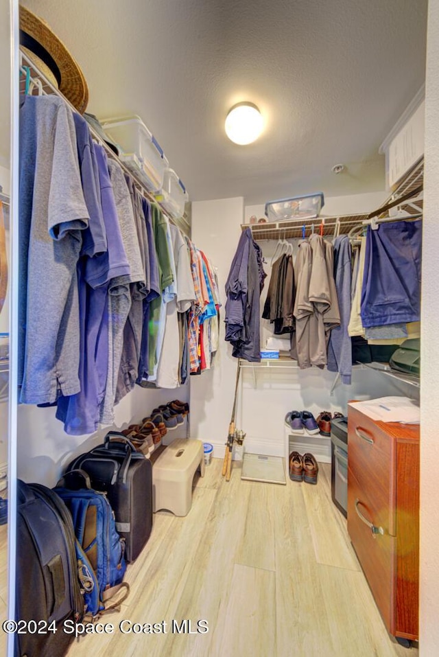 3360 S Atlantic Ave Unit 212, Cocoa Beach, FL 32931 - walk in closet featuring wood finished floors