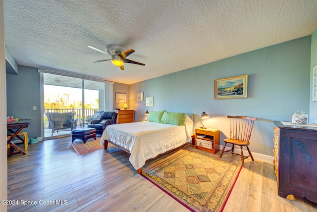 bedroom with access to outside, a textured ceiling, light hardwood / wood-style floors, and ceiling fan