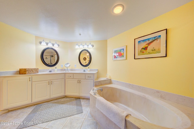 bathroom featuring a bath, tile patterned flooring, and vanity