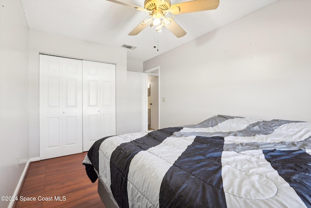 bedroom with dark hardwood / wood-style flooring, a closet, and ceiling fan