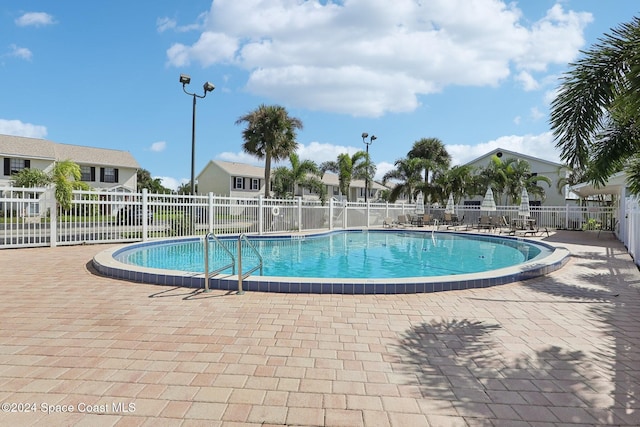 view of swimming pool featuring a patio area