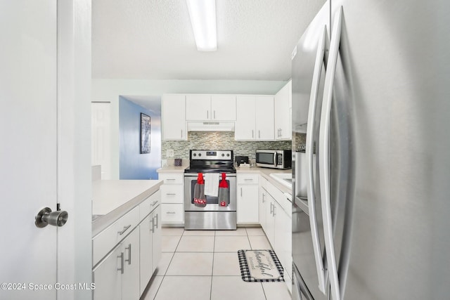 kitchen featuring backsplash, exhaust hood, appliances with stainless steel finishes, and white cabinetry