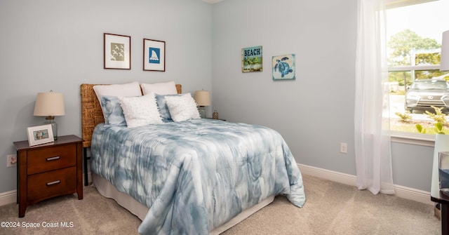 bedroom with light colored carpet