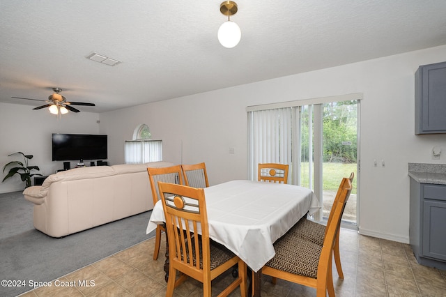 dining room with light tile patterned floors, a textured ceiling, and ceiling fan