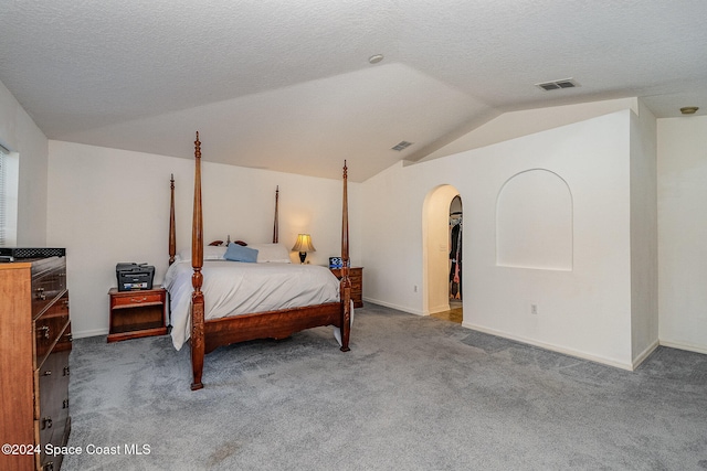 carpeted bedroom featuring vaulted ceiling