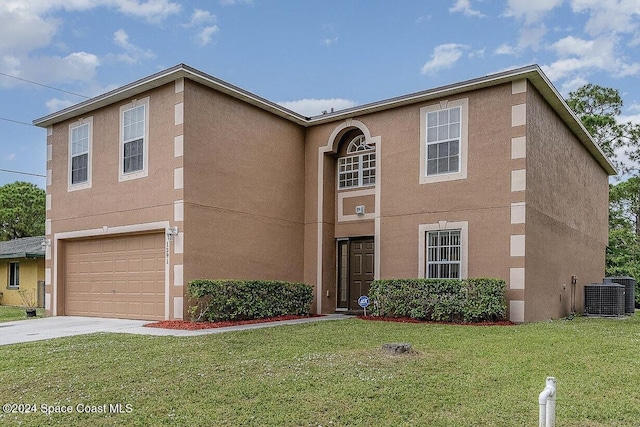 view of front property with a garage, a front yard, and central AC