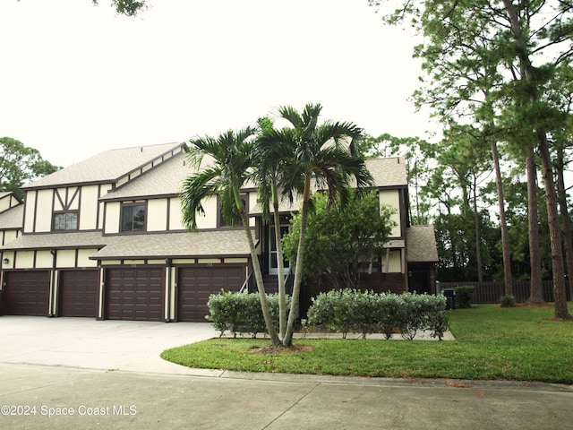 753 Greenwood Manor Cir Unit 15B, West Melbourne, FL 32904 - tudor house with driveway, a garage, stucco siding, and a shingled roof