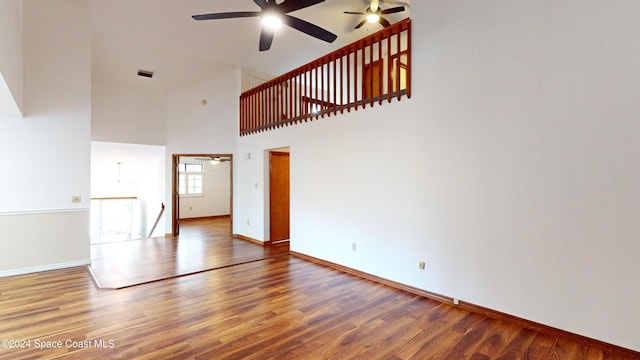 753 Greenwood Manor Cir Unit 15B, West Melbourne, FL 32904 - unfurnished living room with ceiling fan, wood finished floors, baseboards, and a towering ceiling