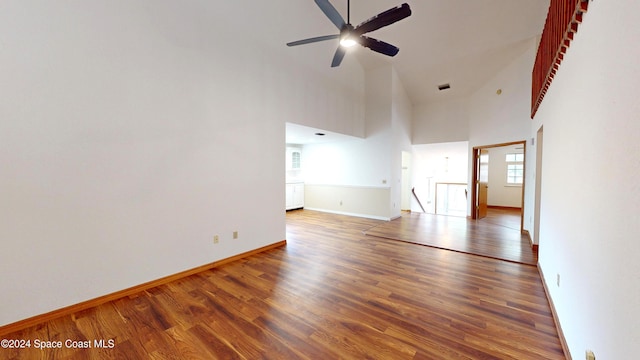 753 Greenwood Manor Cir Unit 15B, West Melbourne, FL 32904 - unfurnished room with wood finished floors, ceiling fan, baseboards, and a towering ceiling