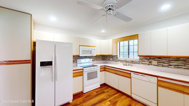 kitchen with sink, ceiling fan, white cabinetry, light hardwood / wood-style flooring, and white appliances