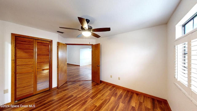 753 Greenwood Manor Cir Unit 15B, West Melbourne, FL 32904 - unfurnished bedroom featuring wood finished floors, a closet, baseboards, and a ceiling fan