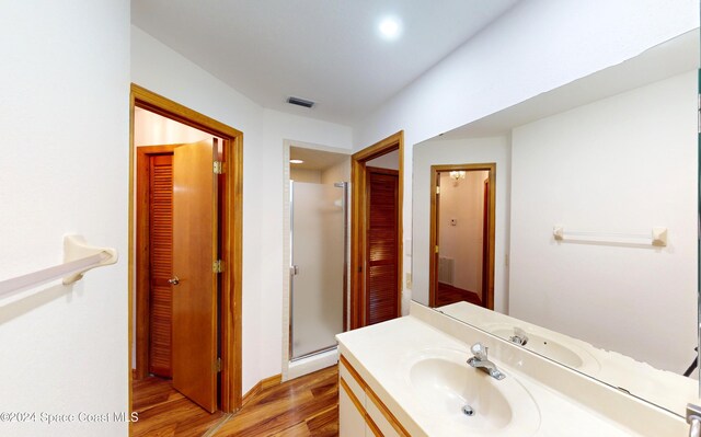753 Greenwood Manor Cir Unit 15B, West Melbourne, FL 32904 - full bath featuring wood finished floors, vanity, a stall shower, and a closet