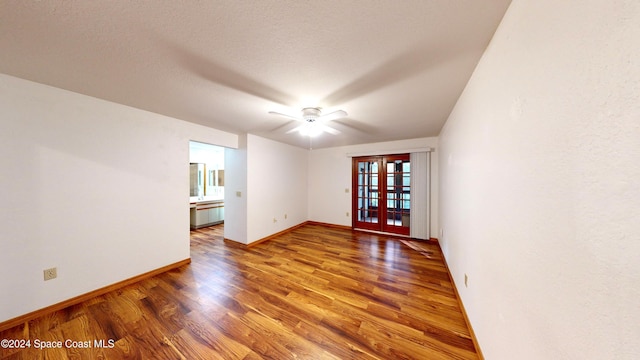 spare room with hardwood / wood-style flooring, ceiling fan, a textured ceiling, and french doors