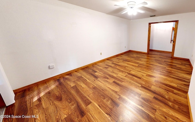 empty room featuring wood-type flooring and ceiling fan