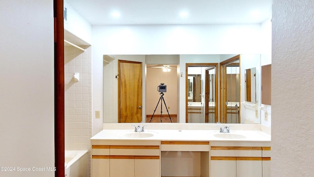 753 Greenwood Manor Cir Unit 15B, West Melbourne, FL 32904 - bathroom featuring double vanity, a ceiling fan, and tub / shower combination