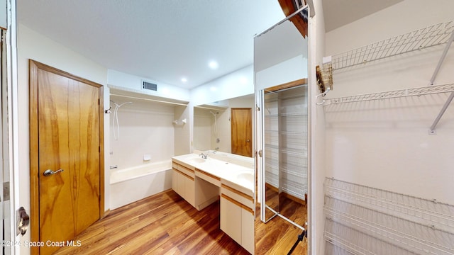 753 Greenwood Manor Cir Unit 15B, West Melbourne, FL 32904 - bathroom featuring wood finished floors, double vanity, shower / bath combination, and recessed lighting