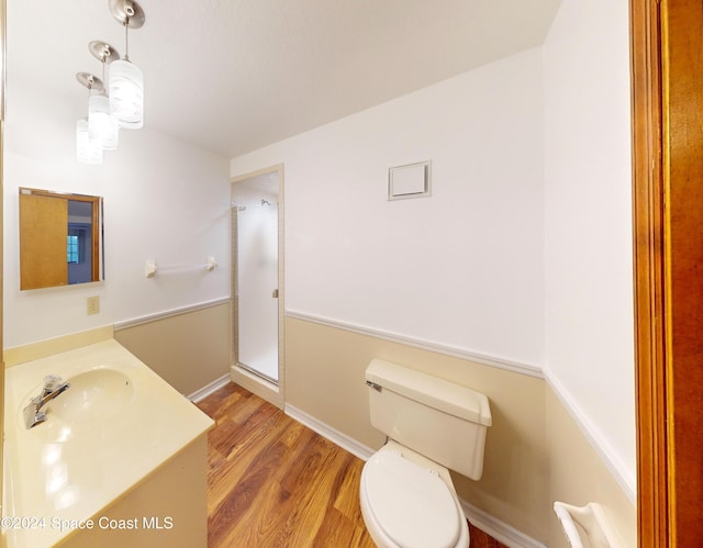 753 Greenwood Manor Cir Unit 15B, West Melbourne, FL 32904 - bathroom with toilet, a stall shower, wood finished floors, and vanity