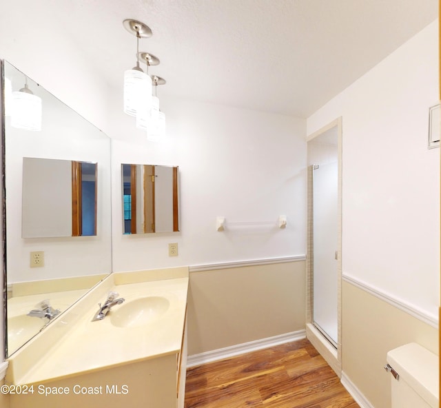 753 Greenwood Manor Cir Unit 15B, West Melbourne, FL 32904 - bathroom featuring vanity, wood finished floors, toilet, a stall shower, and baseboards