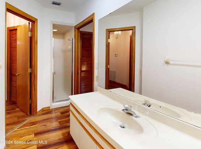753 Greenwood Manor Cir Unit 15B, West Melbourne, FL 32904 - bathroom featuring wood finished floors, a stall shower, vanity, and a closet