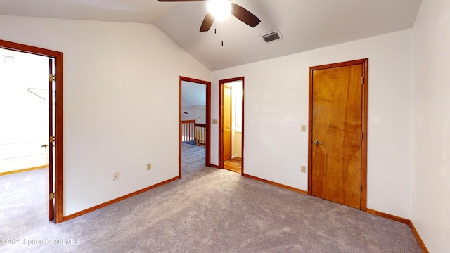 unfurnished bedroom with lofted ceiling, ceiling fan, and light carpet