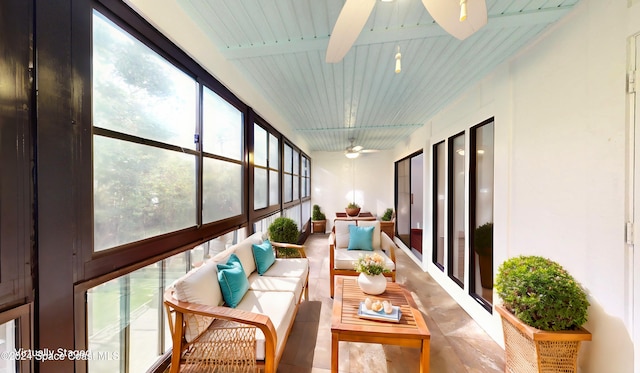 sunroom featuring wood ceiling, ceiling fan, and beam ceiling