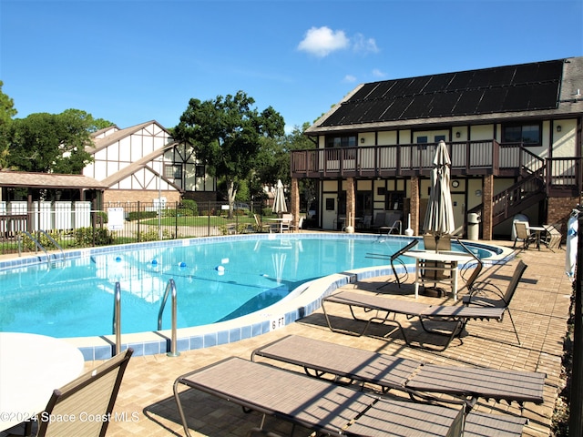 view of swimming pool featuring a deck and a patio area