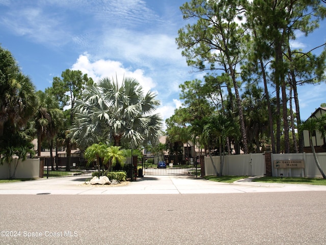 753 Greenwood Manor Cir Unit 15B, West Melbourne, FL 32904 - view of concrete road with a gate, a gated entry, and curbs
