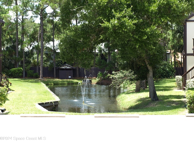 view of yard with a storage unit and a water view