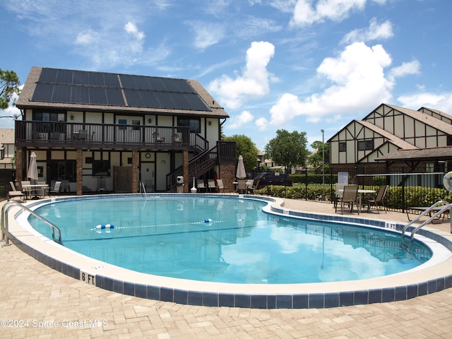 753 Greenwood Manor Cir Unit 15B, West Melbourne, FL 32904 - community pool with stairs, a wooden deck, and a patio