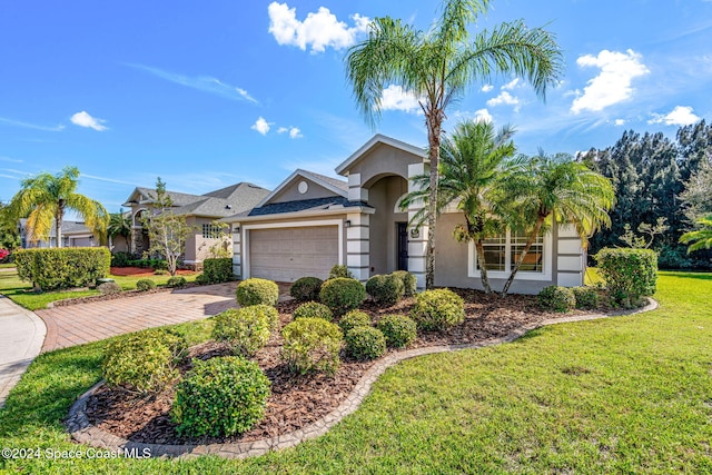 view of front of house with a front lawn and a garage