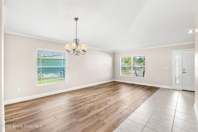 interior space with light hardwood / wood-style floors, crown molding, and a chandelier