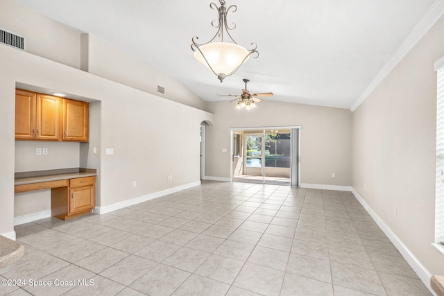 unfurnished living room with built in desk, ceiling fan, vaulted ceiling, crown molding, and light tile patterned floors