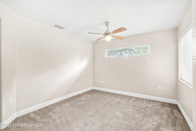 unfurnished room featuring ceiling fan and carpet floors