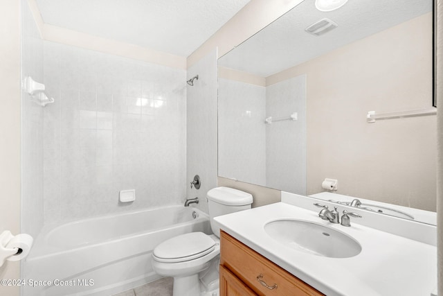 full bathroom featuring a textured ceiling, toilet, tiled shower / bath, vanity, and tile patterned flooring