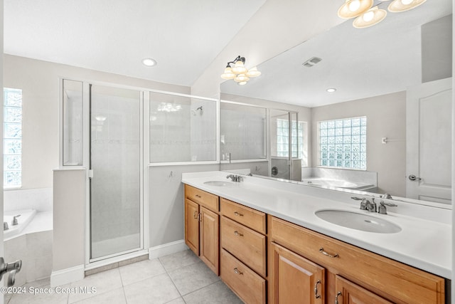 bathroom featuring vanity, shower with separate bathtub, and tile patterned flooring