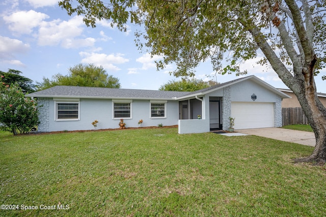 ranch-style house featuring a front yard and a garage