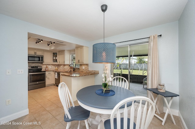 tiled dining room featuring sink