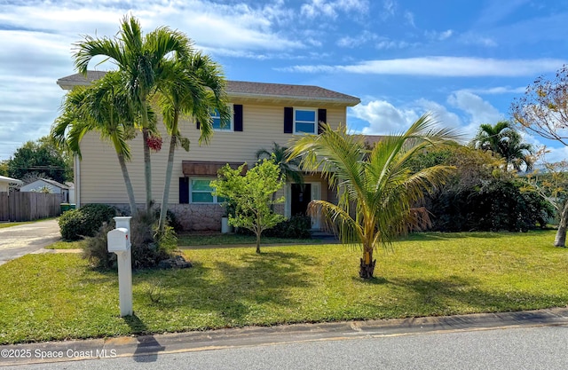 view of front of home with fence and a front yard