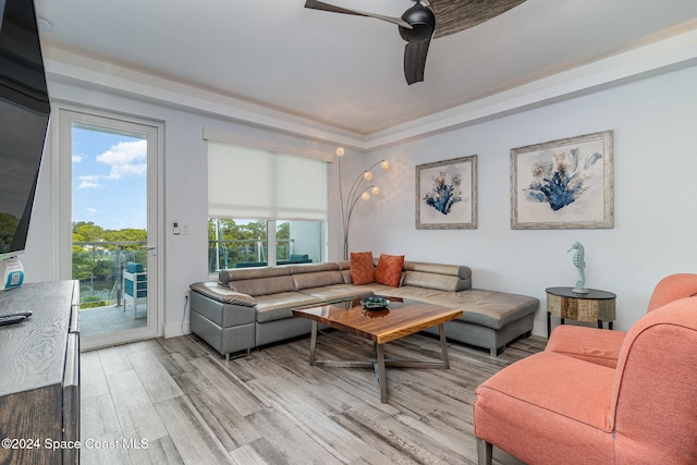 living room with plenty of natural light, ceiling fan, and light wood-type flooring