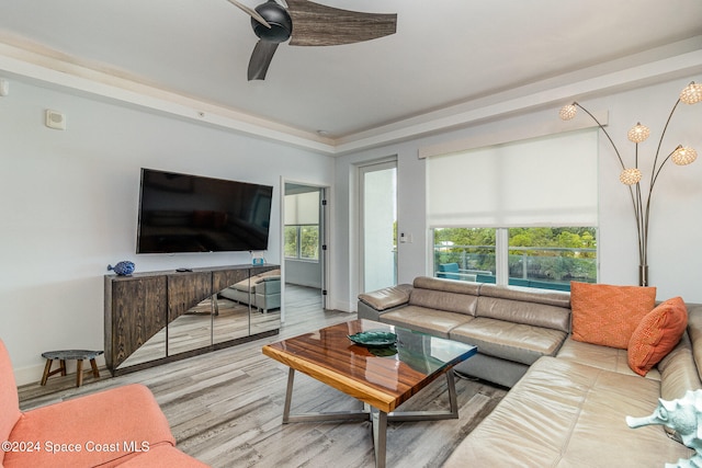 living room featuring light hardwood / wood-style flooring, a wealth of natural light, and ceiling fan