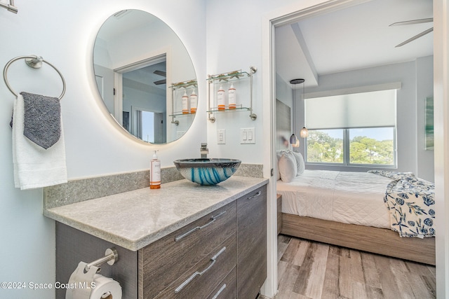 bathroom featuring vanity, wood-type flooring, and ceiling fan