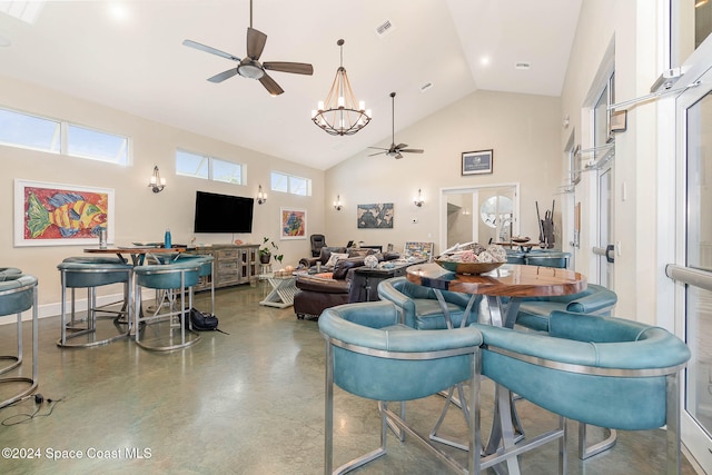 living room featuring high vaulted ceiling and ceiling fan with notable chandelier