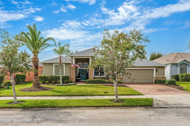 view of front of house with a garage and a front yard