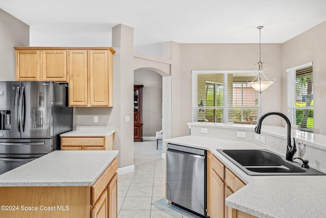 kitchen featuring stainless steel appliances, sink, light brown cabinetry, and light tile patterned floors