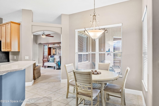 tiled dining space with a wealth of natural light and ceiling fan