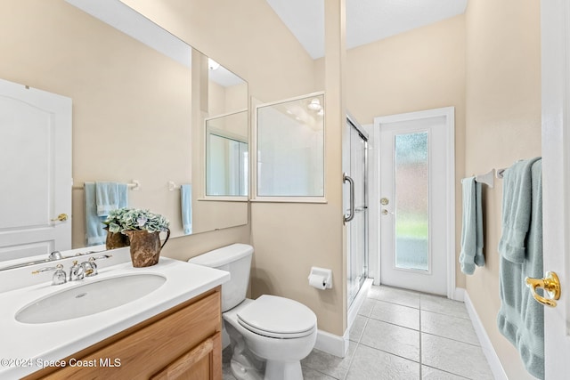 bathroom with tile patterned flooring, vanity, toilet, and a shower with shower door