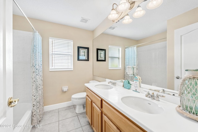 full bathroom with a wealth of natural light, tile patterned floors, vanity, and toilet