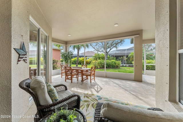 view of patio featuring a lanai